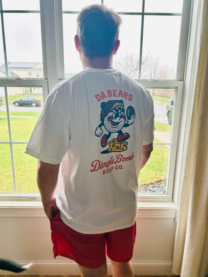 Back view of a white Dimple Bomb Golf Co. Da Bears golf T-shirt featuring Mr. Dimple in a bear hat carrying a football and stepping over cheese, inspired by Chicago football and golf culture.