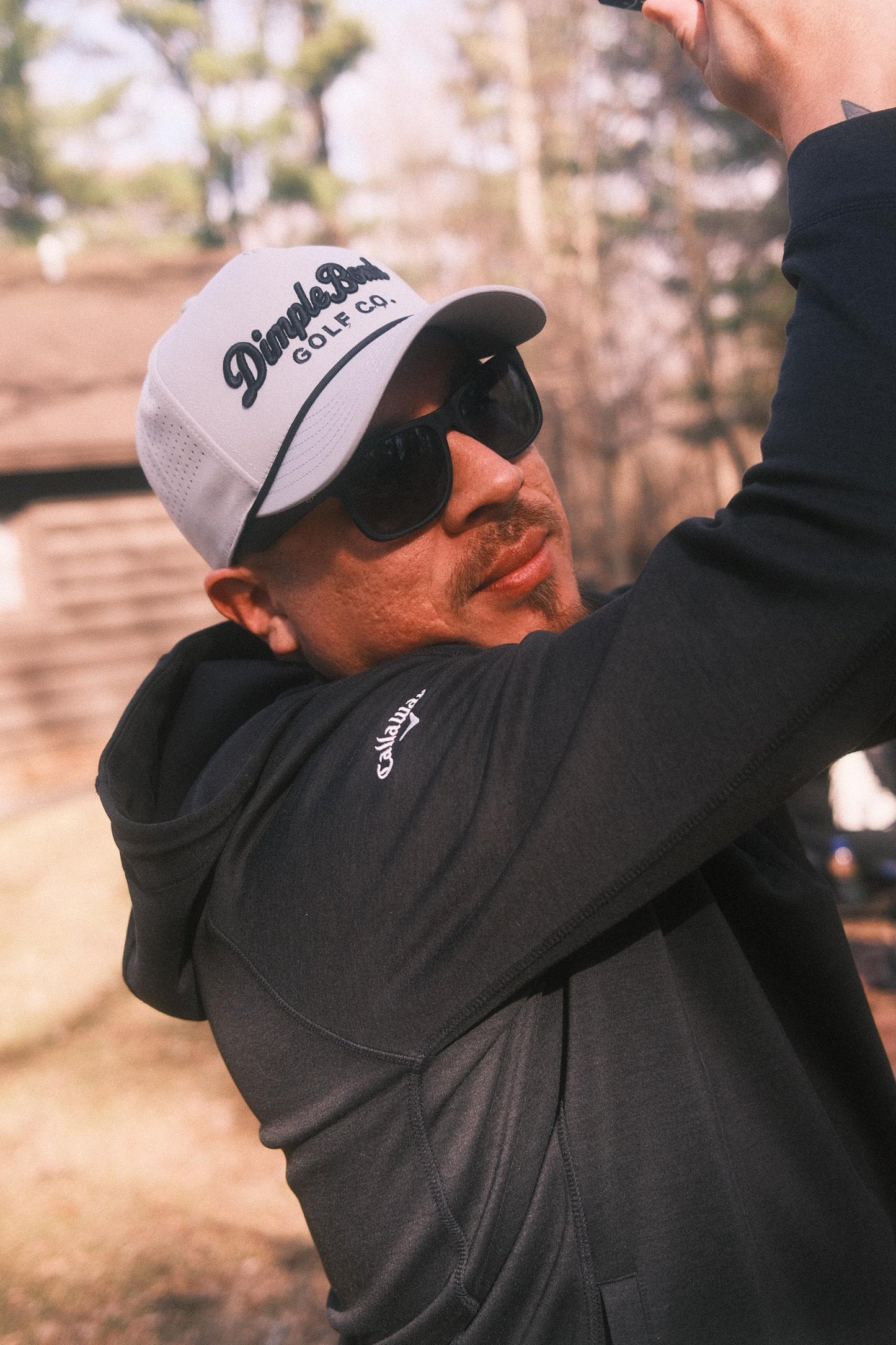 Man wearing grey hat outdoors with a soft background