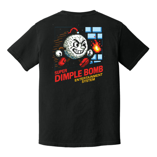 Black golf graphic tee featuring an 8-bit Mr. Dimple golf ball character running through a retro video game scene with “Super Dimple Bomb Entertainment System” text on the back.
